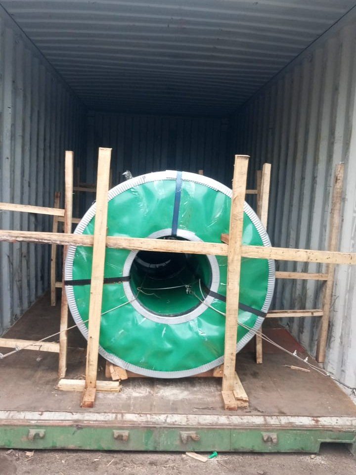 A timber frame in front of and behind a coil inside the container
