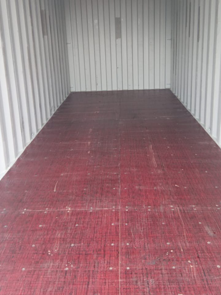 An empty 20-foot container with a clean floor, before loading